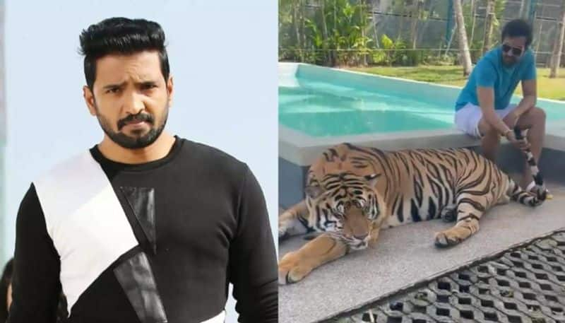 Santhanam pets a tiger in viral video Netizens slam him