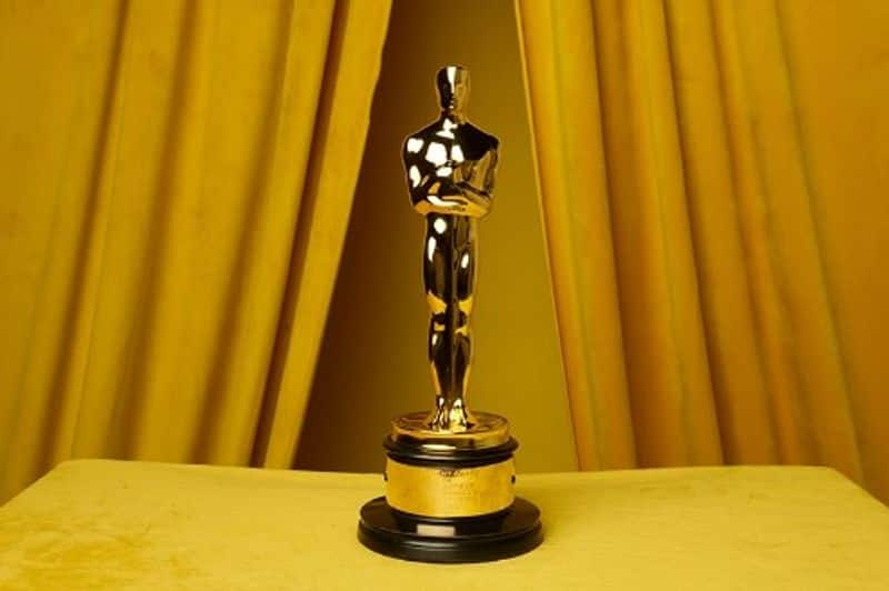 How much is an Oscar award worth and what material is it made of