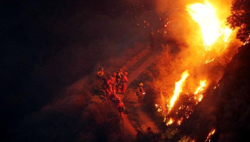 Chile arrests firefighter and a forestry worker on suspicion of starting the fire which killed at least 137 