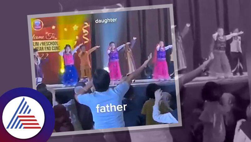 Father enacts dance steps for daughter during performance at school Vin