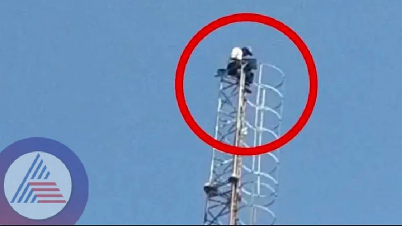 water supply Board contract worker sitting on mobile tower at dharwad rav