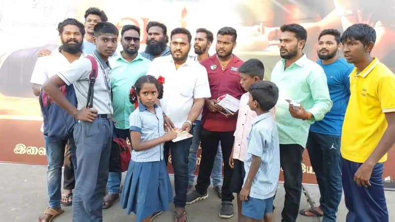 actor Dhanush fans distribute free notebooks to school students for welcoming a vaathi movie in puducherry