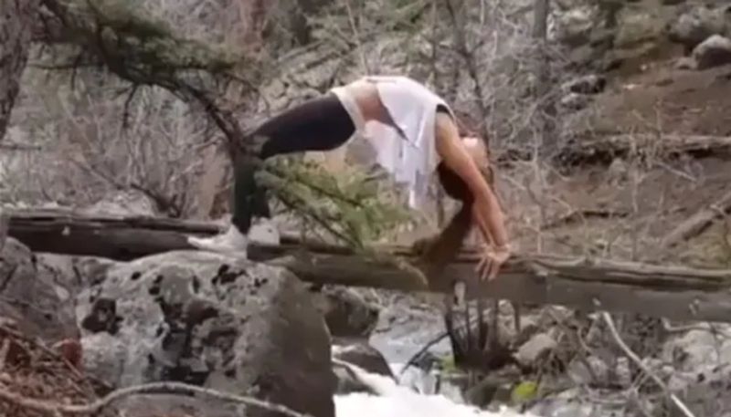 woman falls into river while doing yoga pose hyp 