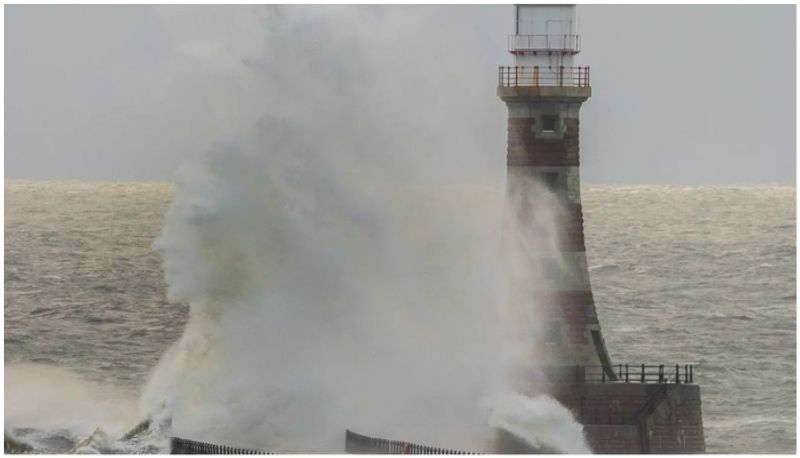 human face in the waves crashing on the lighthouse see the viral image bkg