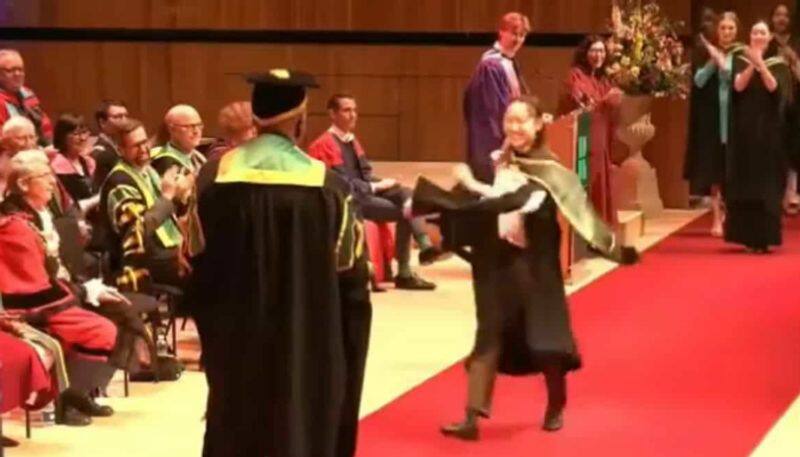 Woman does a backflip at her graduation ceremony azn