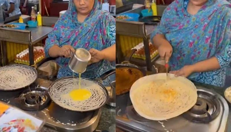 woman prepares spiderman dosa at street food stall hyp 