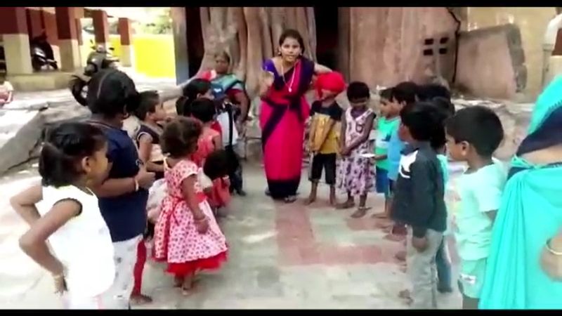 a government school teacher play dance and sing song for To attract students' attention