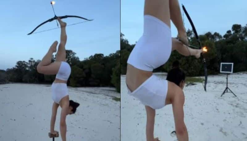 Gymnast shoots flaming arrow with her feet azn 