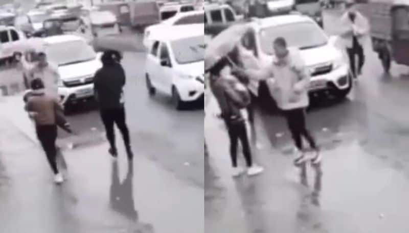 stranger gives his umbrella to a woman who were walking with her child in rain hyp 