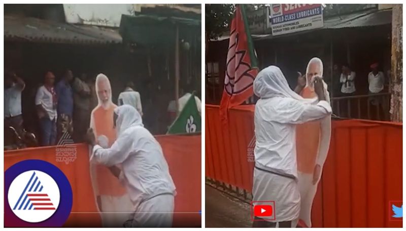 Karnataka election 2023 Prime Minister Narendra Modi fan wiped the rain water on Modi cutout sat