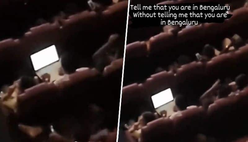 Viral video Bengaluru man spotted working on laptop in movie theatre netizens react watch gcw