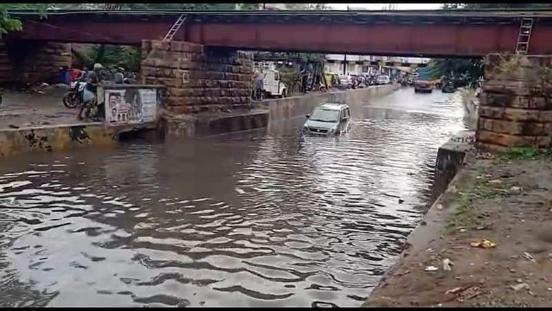 A car stuck in water under the flyover due to heavy rain in Coimbatore