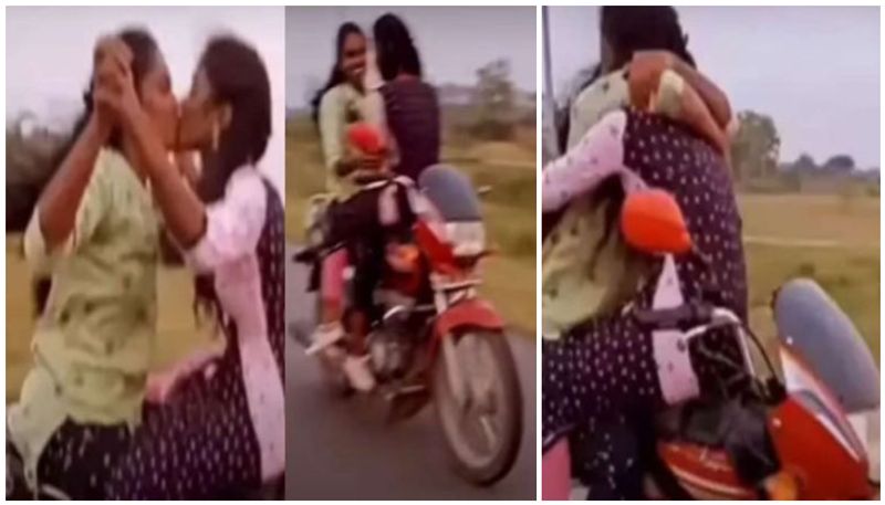 Girls kisses each other while bike riding prm 