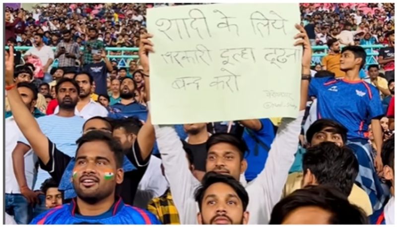 Stop looking for groom with government job Young man's placard goes viral during IPL match bkg 