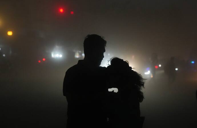 A couple on a road during thunderstorm in Kolkata