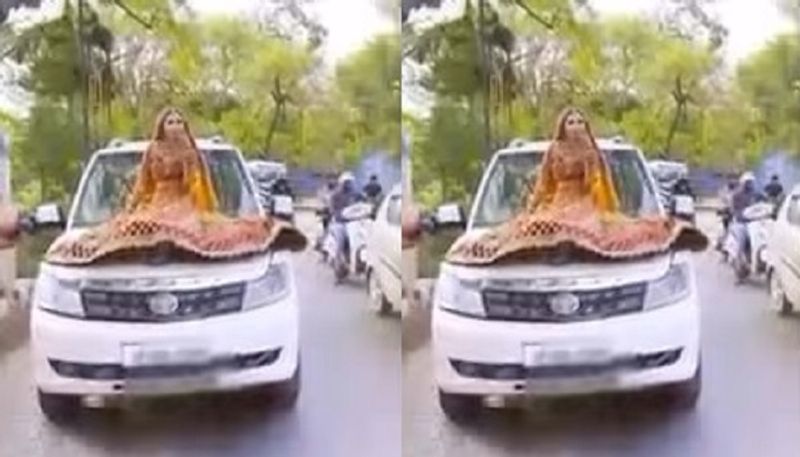 Woman in bridal dress on moving car bonnet shoots Insta reel In prayagraj - bsb