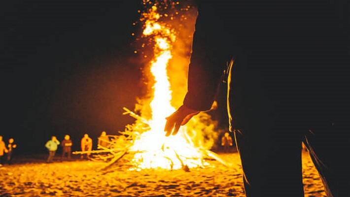  young man lying on a burning pyre in grief of friend s death