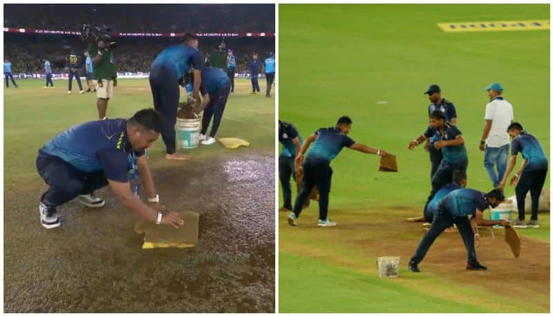 watch video ground staff soak water from narendra modi stadium pitch with sponge saa