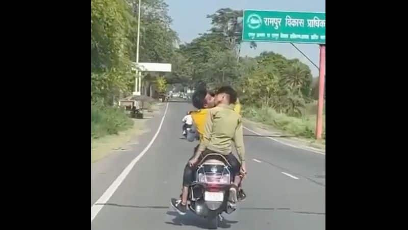 Guys Kiss On Moving Scooty in UP the video goes viral on social 