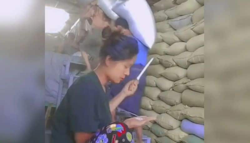 woman checking quality of rice in a warehouse the video going viral hyp