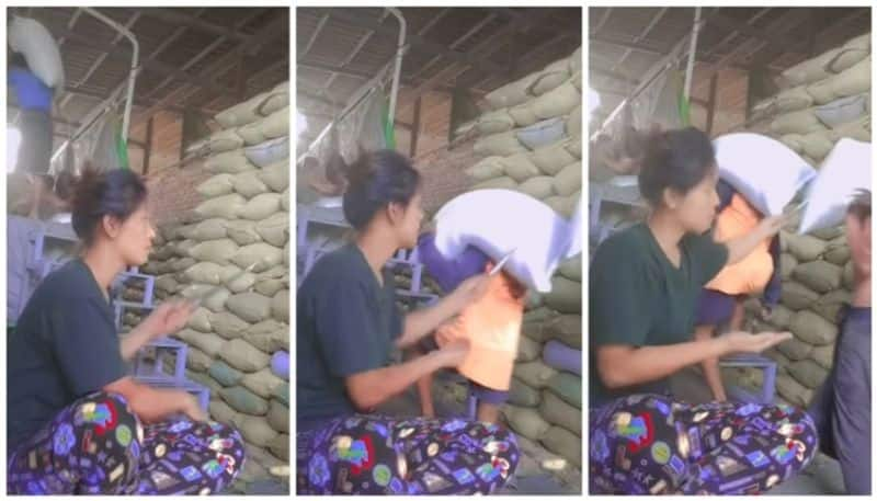 woman quality inspection on rice bags in viral video bkg