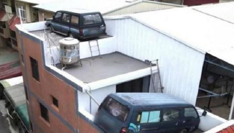 Tired of paying fines for no parking, car  owner parks cars on top of house!-sak