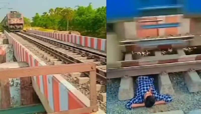 man lying beneath the railway tracks rlp