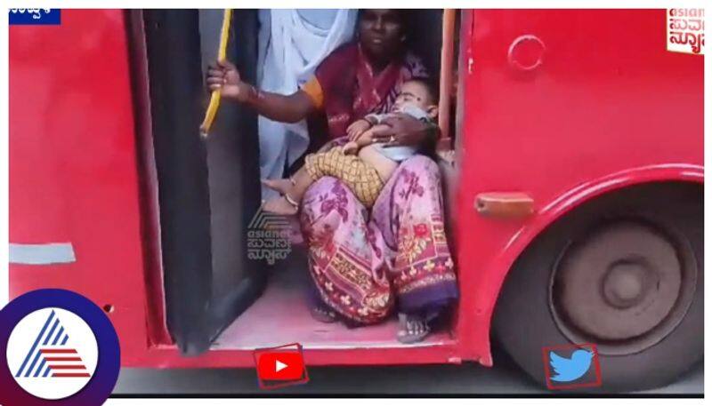 woman carrying child sits on KSRTC bus footboard and travels in Koppal gow