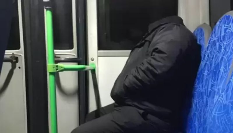 truth behind the viral photo in which a headless man sitting inside public transport hyp