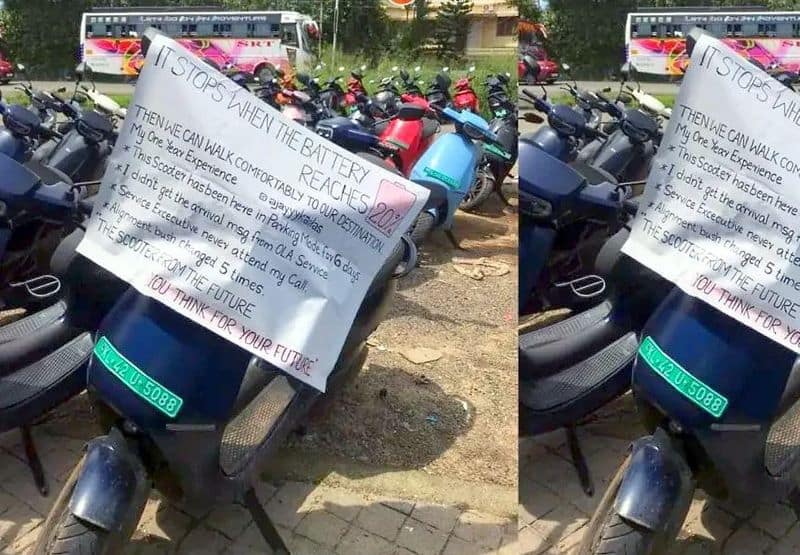 Ola S1 Pro electric scooter owner protests in front of service centre with banner-sak