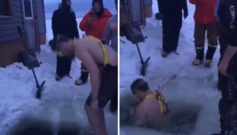 man takes a dip in ice cold water to take lost phone hyp