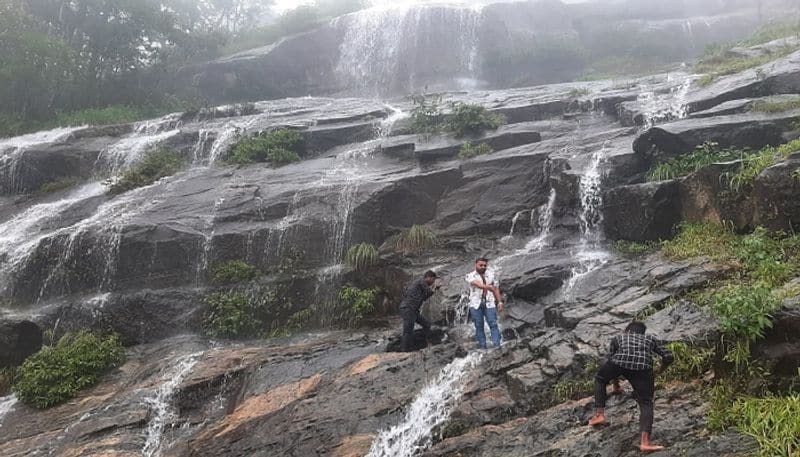 Tourists Climbing the Rock at the Dangerous Place at Charmadi Ghat in Chikkamagaluru grg