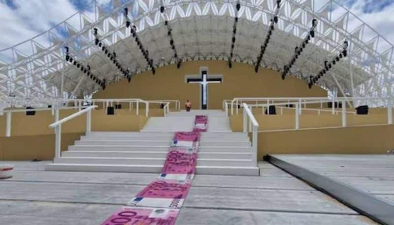 Artist create banknote carpet to slam cost of Popes visit rlp