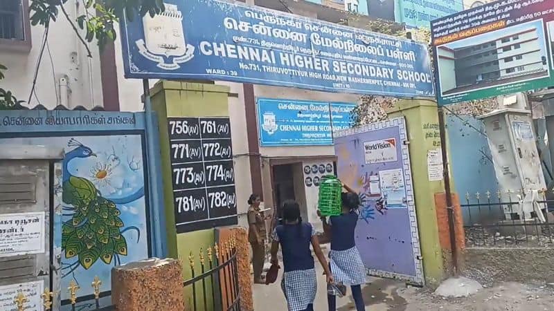 government school students lifting a water cans with youniform in chennai