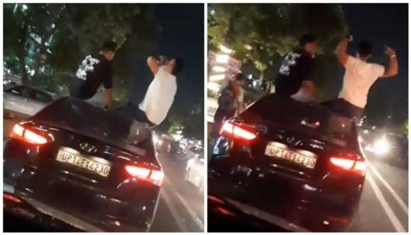 Video of drunk sitting on top of moving car goes viral bkg 