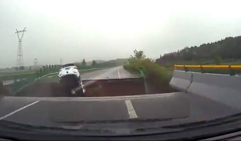 WATCH Terrifying video shows car plunging into massive crater in China as Typhoon Doksuri destroys roads snt