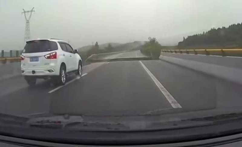 car plunges into massive crater as bridge collapses in front of it in China as deadly flood stunning video