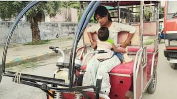 amroha girl pooja ride e rikshaw with her baby tied on her tummy ZKAMN