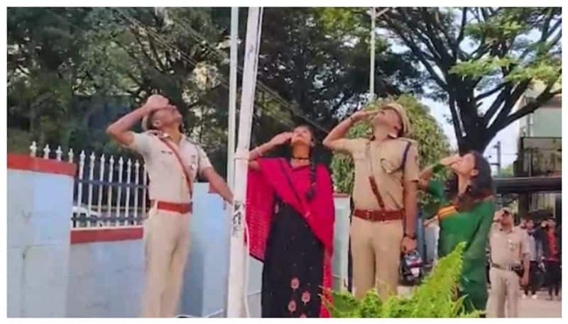 flag hoisting by tribal woman in hassan nbn