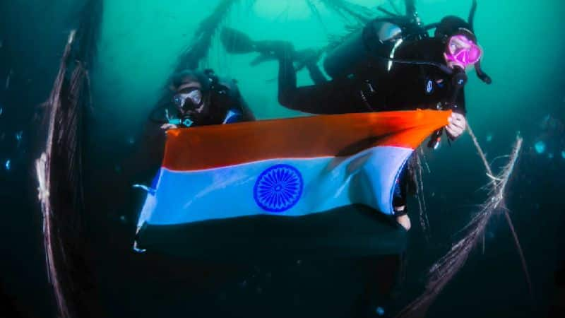 Deep sea swimmers flagging in deep sea for independence day