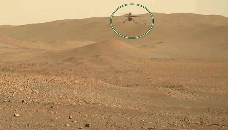 NASA experimental Ingenuity helicopter flying and landing in Mars san