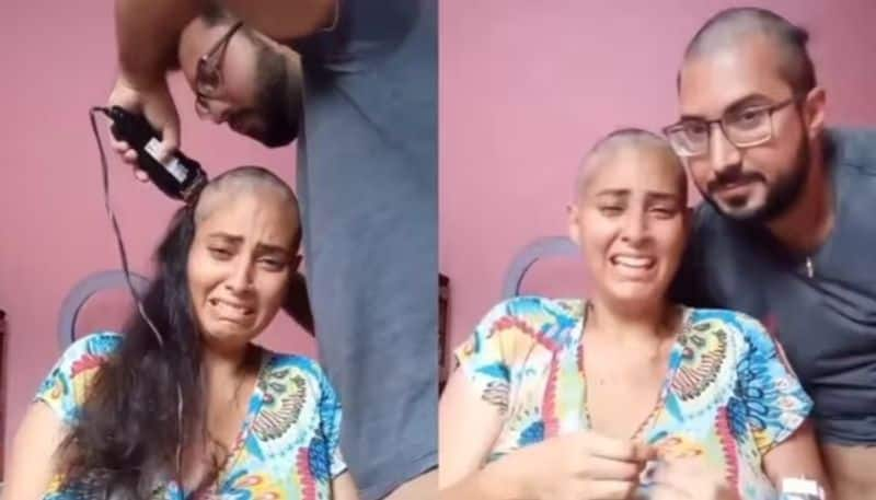 husband shaves his head as support to his wife who suffer cancer disease hyp