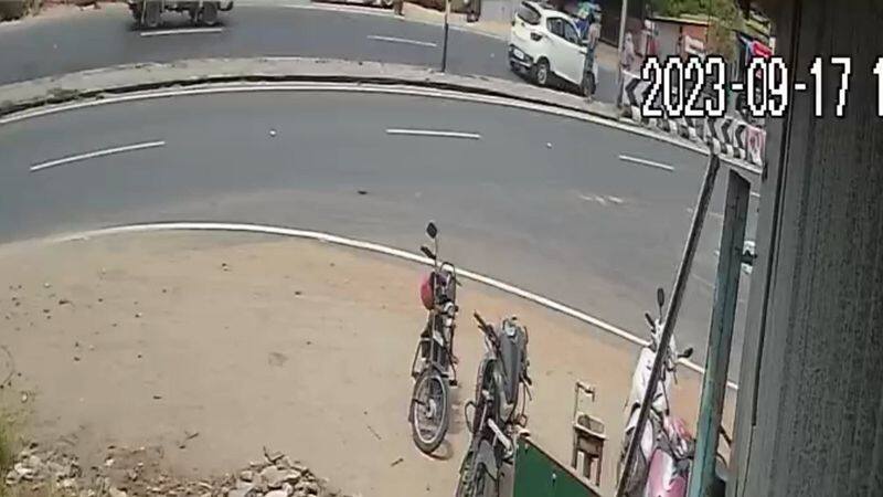 car hit a old man who try to cross a road in tirupur district video goes viral vel 