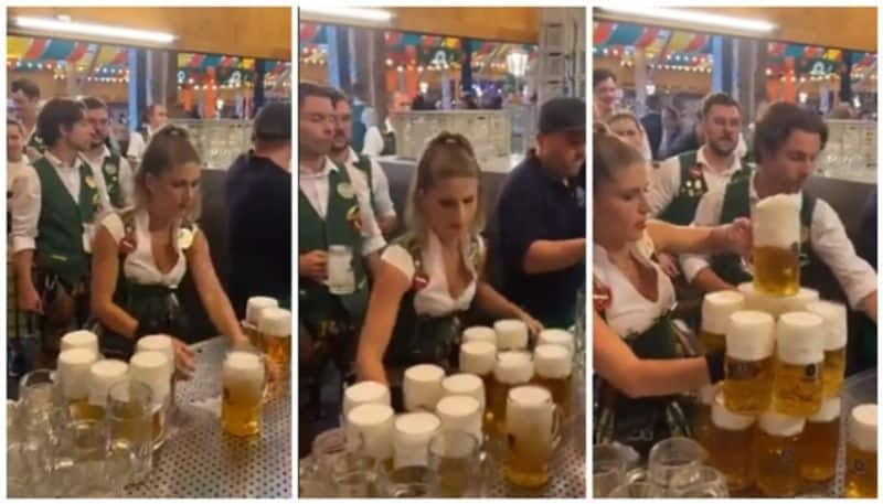 Netizens count the beer mugs in the hands of the young woman at Oktoberfest bkg 