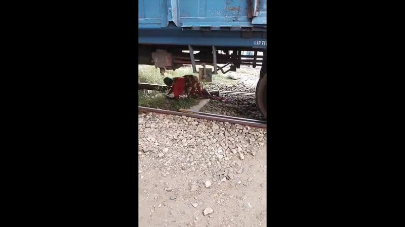 A woman gate keeper bravely rescued an old woman trapped under a train in Trichy vel