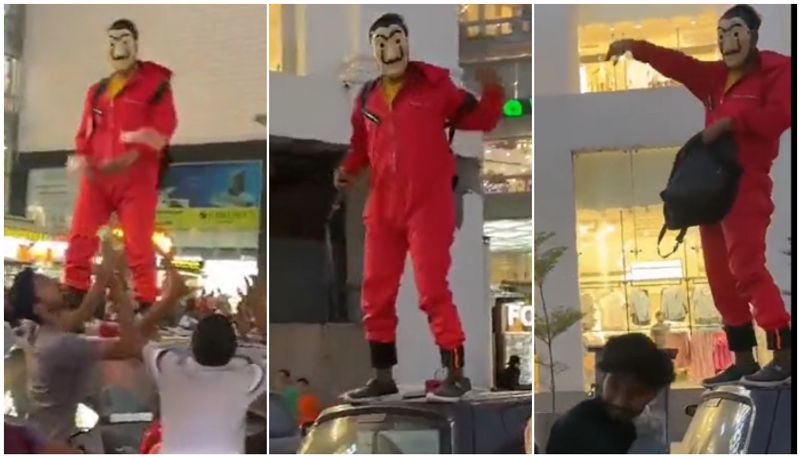 Money Heist in town Man Dressed As Money Heist Character Throws Money in Air watch video btb