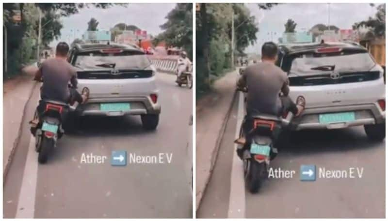 Viral video of Ather electric scooter rider pushing and moving a battery empty Tata Nexon EV prn