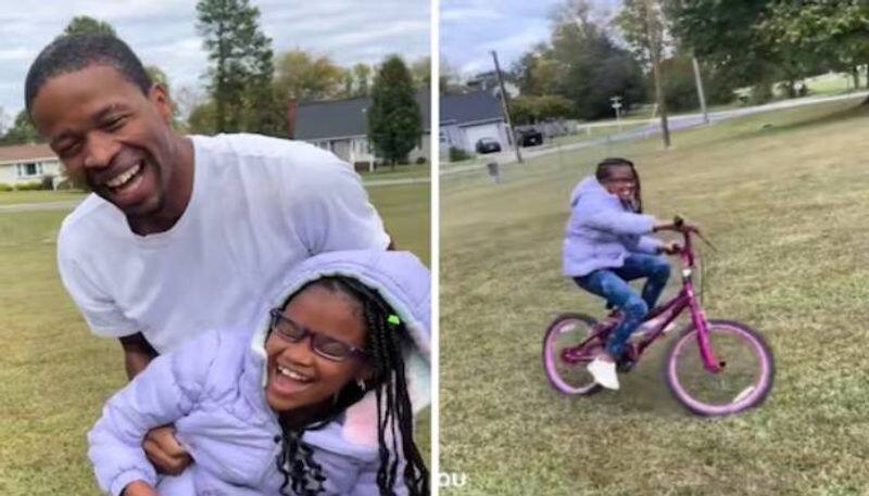 dad helps visually challenged daughter to ride a bicycle rlp