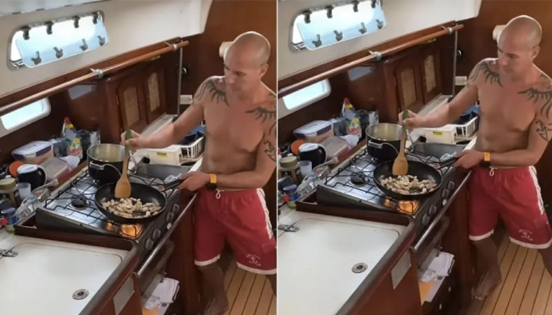 man cooking inside a boat during hurricane hyp