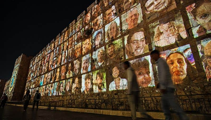 Faces of Israeli hostages projected on Jerusalem walls, candle-light vigil marks 1 month since Hamas attack snt